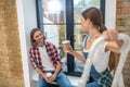 Young couple having coffee after painting the walls Royalty Free Stock Photo