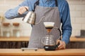 Coffee brewing gadgets. Male bartender brewing pourover coffee at bar. Royalty Free Stock Photo