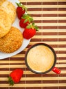 Coffee, buns and strawberries on table