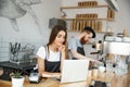 Coffee Business Concept - beautiful caucasian bartender barista or manager working and planing in laptop at modern Royalty Free Stock Photo