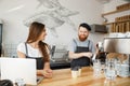 Coffee Business Concept - Positive young bearded man and beautiful attractive lady barista couple enjoy working together Royalty Free Stock Photo