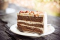 Coffee cake with almond on white plate in coffee shop. Royalty Free Stock Photo