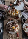 Coffee and cake with friends or family on a dinner table with platter of sliced cake