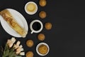 Coffee, cakes and bun on black background. Royalty Free Stock Photo