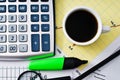 Coffee and calculator on paper table with diagram Royalty Free Stock Photo