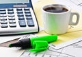 Coffee and calculator on paper table with diagram Royalty Free Stock Photo