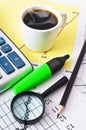 Coffee and calculator on paper table with diagram Royalty Free Stock Photo