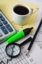 Coffee and calculator on paper table with diagram Royalty Free Stock Photo