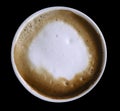 Coffee cappuccino in a white cup isolated on the black background with clipping path. Top view. Close-up. Royalty Free Stock Photo