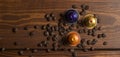 Coffee capsule with coffee beans on wooden table