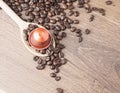 Coffee capsule and wooden spoon top view Royalty Free Stock Photo