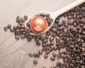 Wooden spoon and coffee capsule close up Royalty Free Stock Photo