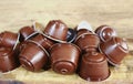 Coffee capsules on brown wooden table for espresso machine