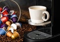 Coffee capsules pods on raw beans background with espresso cup and home coffee machine Royalty Free Stock Photo