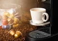 Coffee capsules pods on raw beans with espresso cup and home coffee machine Royalty Free Stock Photo