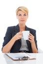 Coffee, checklist or portrait of a businesswoman at a desk for recruitment, hiring or interview in studio. Drinking tea