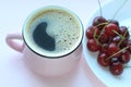 Coffee and cherries. Minimalistic concept, red cherry on white plate. Top view, copy space