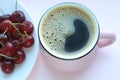 Coffee and cherries. Minimalistic concept, red cherry on white plate. Top view, copy space