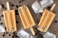 Coffee chocolate chip popsicles on dark metallic background