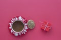 Coffee in Christmas cup, cookie and gift box on a red background top view Royalty Free Stock Photo