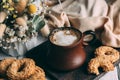 Coffee clay cup with natural aromatic coffee on wooden board.