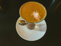 Coffee cocktail in a glass cup on a table with cream