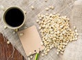 Coffee and coffee beans with brown paper label on sackcloth. Royalty Free Stock Photo