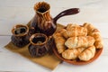 Coffee composition with croissants, set on wooden table