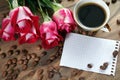 Coffee concept. roses and coffee. cup of coffee and a bouquet of roses on a wooden table. morning coffee and note. copy spaces. Royalty Free Stock Photo