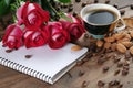 Coffee concept. roses and coffee. cup of coffee and a bouquet of roses on a wooden table. morning coffee and note. copy spaces. Royalty Free Stock Photo