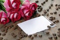 Coffee concept. roses and coffee. cup of coffee and a bouquet of roses on a wooden table. morning coffee and note. copy spaces. Royalty Free Stock Photo