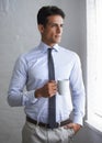 Coffee and contemplation. A handsome young businessman having a cup of coffee and looking out a window. Royalty Free Stock Photo