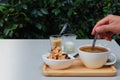 Coffee and cookie on white table in restaurant garden. Royalty Free Stock Photo