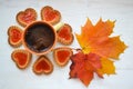 Coffee with cookies in forme of flower in hearts top view, autumn bright colors
