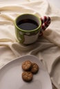 Coffee and Cookies for Santa Clause for Christmas. Plate of cookies on the bed with Christmas pinecones. Large well in green and r Royalty Free Stock Photo