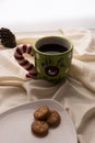 Coffee and Cookies for Santa Clause for Christmas. Plate of cookies on the bed with Christmas pinecones. Large well in green and r Royalty Free Stock Photo