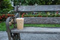 Coffee cool moment the sun is low. On a wooden chair in the park Royalty Free Stock Photo