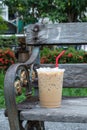 Coffee cool moment the sun is low. On a wooden chair in the park Royalty Free Stock Photo