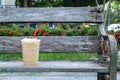 Coffee cool moment the sun is low. On a wooden chair in the park Royalty Free Stock Photo