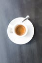 coffee couple with hot fresh espresso and metal tea spoon on grey plastic surface. Vertical geometrical composition. Top