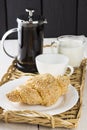 Coffee, croissant, milk on a wattled tray Royalty Free Stock Photo