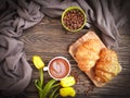 coffee, croissant, morning tulip flower on wooden background