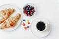 Coffee, croissants and berries breakfast on a white table. Top view, flat lay Royalty Free Stock Photo