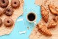 Coffee croissants and chocolate doughnuts with smart phone mock up