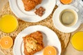 Coffee with croissants, pieces of chocolate, orange juice and tangerines for breakfast Royalty Free Stock Photo