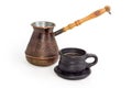 Coffee in cup against the vintage copper coffee pot Royalty Free Stock Photo