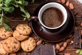 Coffee cup, beans, almond, chocolate and cookie on old kitchen table. Royalty Free Stock Photo