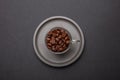 Coffee cup and beans on black color background, top view Royalty Free Stock Photo