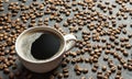 Coffee cup and beans with bright light on black rustic vintage table,Sparkling Coffee concept background.