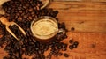 Coffee cup with Coffee beans, burlap sack and with cinnamon sticks Royalty Free Stock Photo